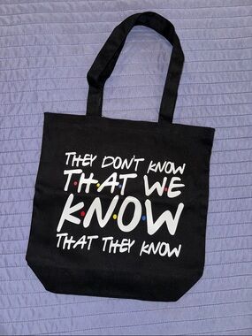 Black Canvas Tote Bag with White Script "They Don't Know That We Know"